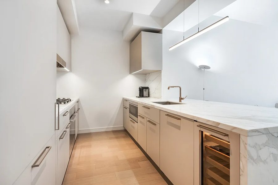 305 East 51st Street, Residence 4H &mdash; chef&rsquo;s kitchen in Calacatta marble with Miele appliances