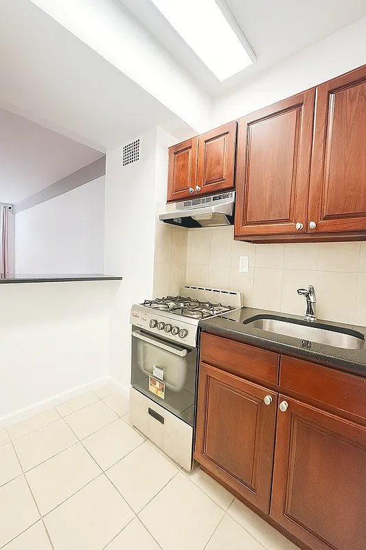 Kitchen with cherry wood cabinetry and stainless appliances
