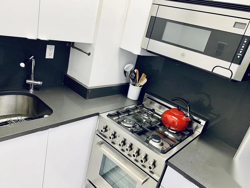 240 East 46th Street, #5A &mdash; Kitchen, showing the marble flooring and lacquer cabinetry