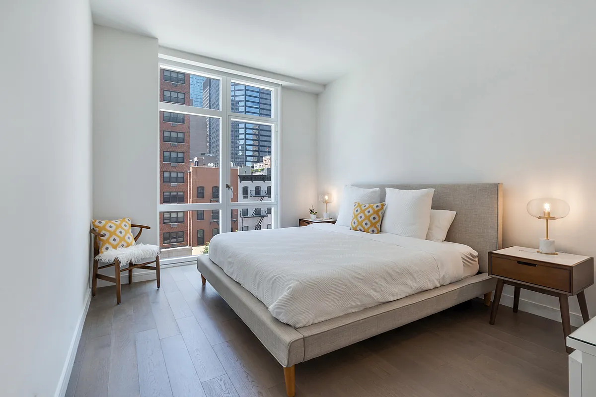 305 East 51st Street, #4H &mdash; Primary bedroom with west-facing floor-to-ceiling windows